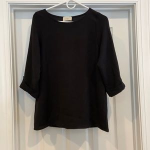 Black blouse with pearl buttons on sleeves